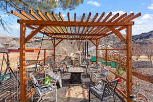 View of patio / terrace featuring a fire pit, a mountain view, and a pergola