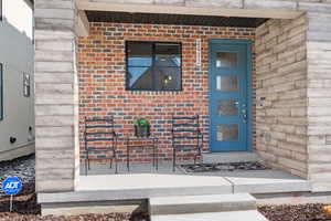 Property entrance featuring brick siding