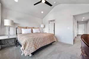 Bedroom with ceiling fan, high vaulted ceiling, recessed lighting, light colored carpet, and baseboards