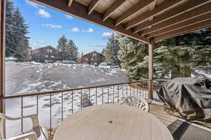 Snow covered deck featuring area for grilling