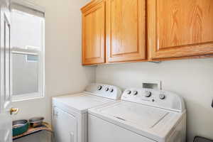 Washroom with washing machine and dryer and cabinet space