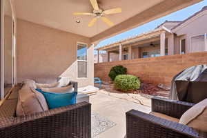 View of patio / terrace with a ceiling fan, a grill, fence, and an outdoor living space