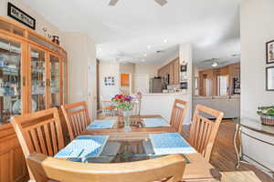 Dining area featuring wood finished floors, a ceiling fan, and recessed lighting