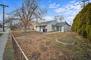 Exterior space with fence and roof with shingles