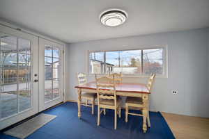 Dining room with french doors and wood finished floors