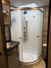 Bathroom with vanity and a stall shower