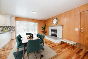 Dining room featuring wood walls and light hardwood / wood-style flooring