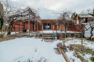 View of snow covered rear of property