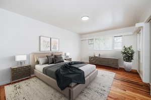 Bedroom with hardwood / wood-style floors