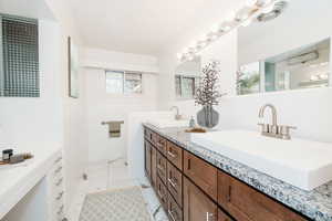 Bathroom featuring tasteful backsplash and vanity