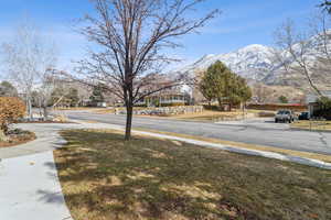 View of street with a residential view, curbs, a mountain view, and sidewalks