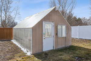 View of outdoor structure featuring a fenced backyard and an outdoor structure