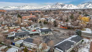 Snowy aerial view featuring a residential view and a mountain view