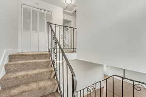 Stairway featuring wood finished floors