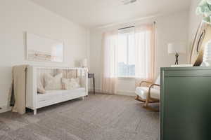 Sitting room with carpet floors, visible vents, and baseboards