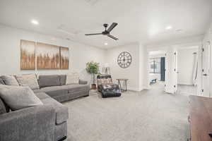 Living area with recessed lighting, visible vents, baseboards, carpet, and attic access