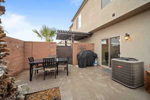 View of patio / terrace with outdoor dining area, fence, a pergola, and central air condition unit