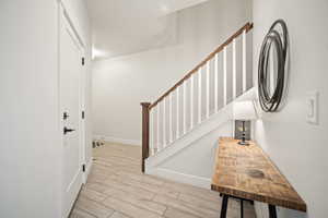 Stairs with baseboards and wood tiled floor