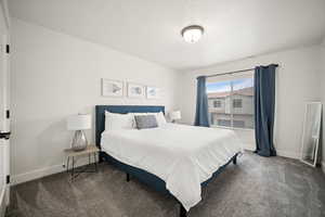 Carpeted bedroom with visible vents and baseboards