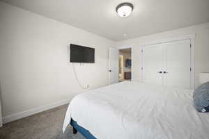 Bedroom featuring a closet, carpet flooring, and baseboards