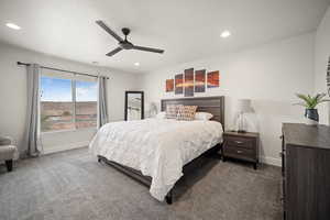 Carpeted bedroom with ceiling fan, baseboards, and recessed lighting