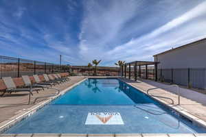 Community pool with a gazebo, fence, and a patio