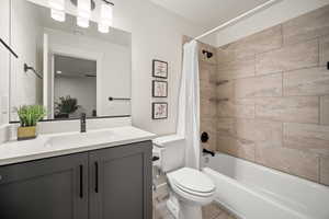 Bathroom with toilet, visible vents, shower / bath combo with shower curtain, and vanity