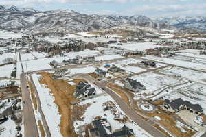 Snowy aerial view with a residential view and a mountain view