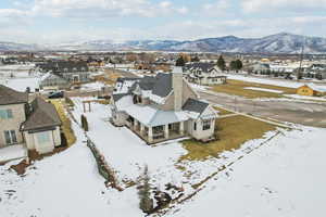 Snowy aerial view with a residential view and a mountain view