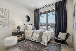 Carpeted bedroom featuring visible vents, a mountain view, and baseboards