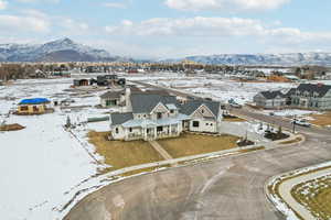 Snowy aerial view featuring a residential view and a mountain view