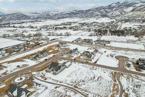 Snowy aerial view with a residential view and a mountain view