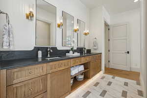 Full bath featuring double vanity and a sink