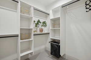 Spacious closet with light colored carpet