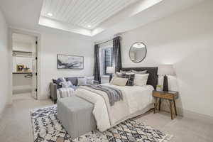 Bedroom featuring recessed lighting, a raised ceiling, light colored carpet, and baseboards