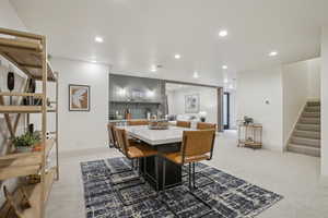 Dining room with recessed lighting, light carpet, stairway, and baseboards