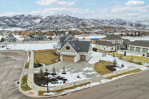 Snowy aerial view featuring a residential view and a mountain view