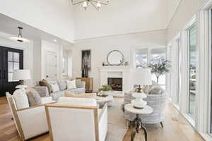 Living room featuring a wealth of natural light, light wood-type flooring, visible vents, and a fireplace