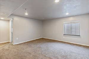 Unfurnished room featuring carpet, visible vents, baseboards, and recessed lighting