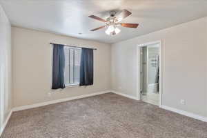 Unfurnished room featuring a textured ceiling, ceiling fan, light colored carpet, visible vents, and baseboards