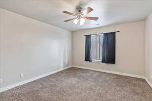 Unfurnished room featuring visible vents, a ceiling fan, carpet flooring, a textured ceiling, and baseboards