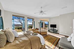 Bedroom featuring baseboards, a ceiling fan, wood finished floors, access to outside, and crown molding