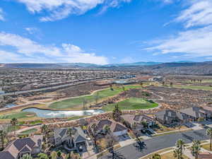 Drone / aerial view with a residential view, golf course view, and a water and mountain view