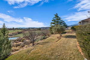 View of yard featuring a water and mountain view