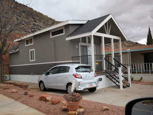 View of front of house with roof with shingles and a mountain view