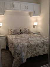 Bedroom with dark wood finished floors