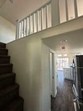 Stairs featuring wood finished floors