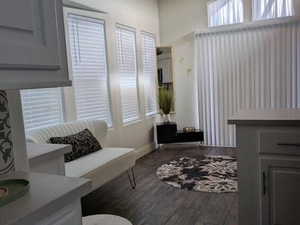 Living area with wood finished floors and baseboards