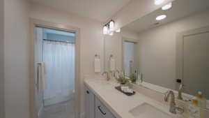 Full bathroom featuring visible vents, double vanity, a sink, and toilet