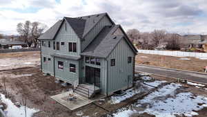 Exterior space with board and batten siding and roof with shingles
